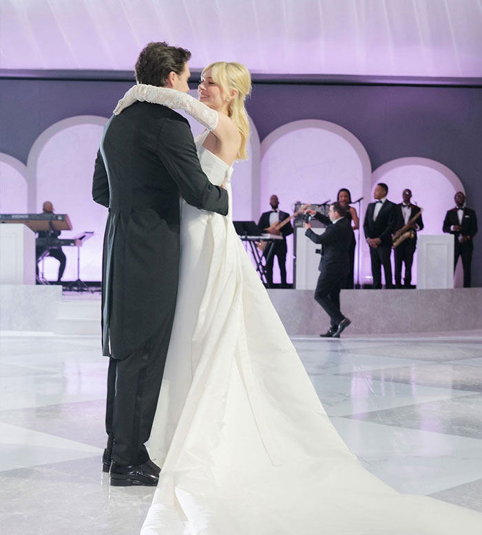 Bride and groom dancing at wedding with live band playing, related to DJ at Brooklyn Beckham's wedding dance accusations.