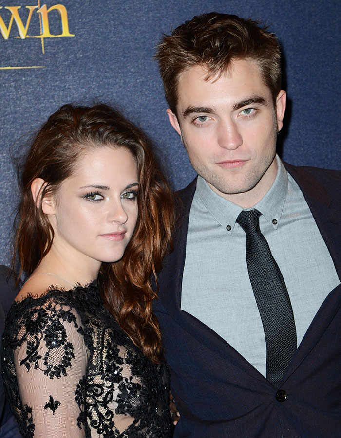 Kristen Stewart posing with a male companion at an event, hinting at a deeper reason behind her possible US exit.