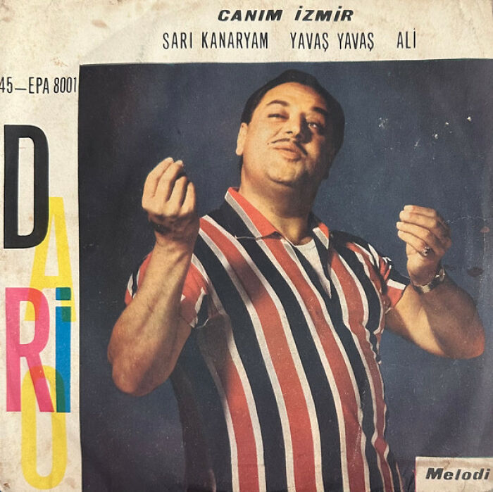 Vintage hilariously bad album cover featuring a man in a striped shirt with an exaggerated facial expression.