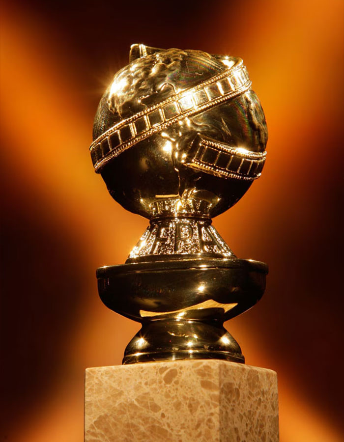 Golden Globe trophy on marble pedestal with warm lighting, symbolizing Cynthia Erivo Golden Globes context