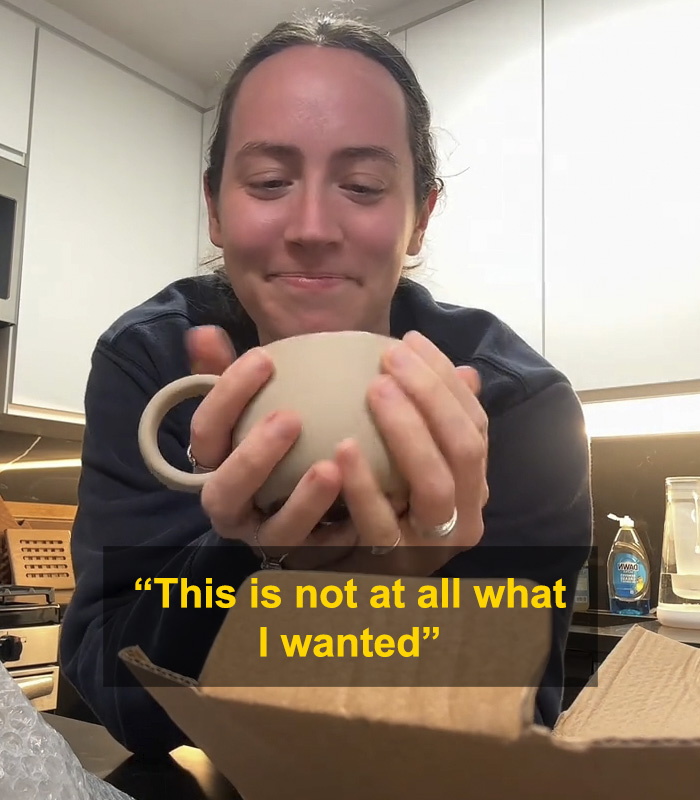 Woman holding a mug gift from fiancé, sparking huge relationship debate online with mixed emotions visible. Woman holding a mug gift from fiancé, sparking huge relationship debate online with mixed emotions visible.