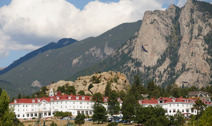 Historic haunted hotel with red roofs nestled in the mountains, a top haunted place known for dark secrets and nightly screams.