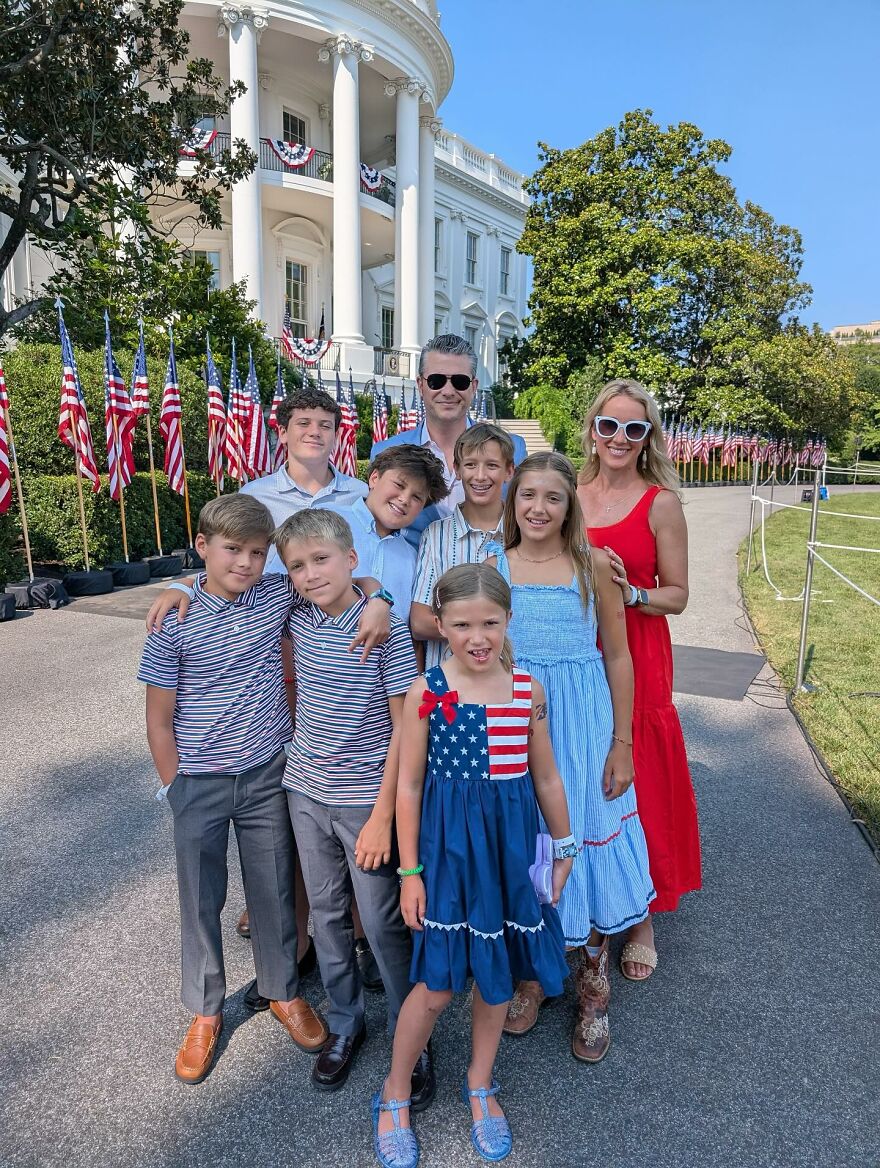 Pete Hegseth&rsquo;s family posing outside the White House with American flags and festive patriotic decorations.
