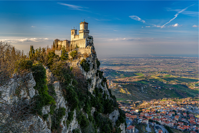 Medieval fortress perched on a cliff overlooking a vast landscape, representing one of the oldest countries in the world.