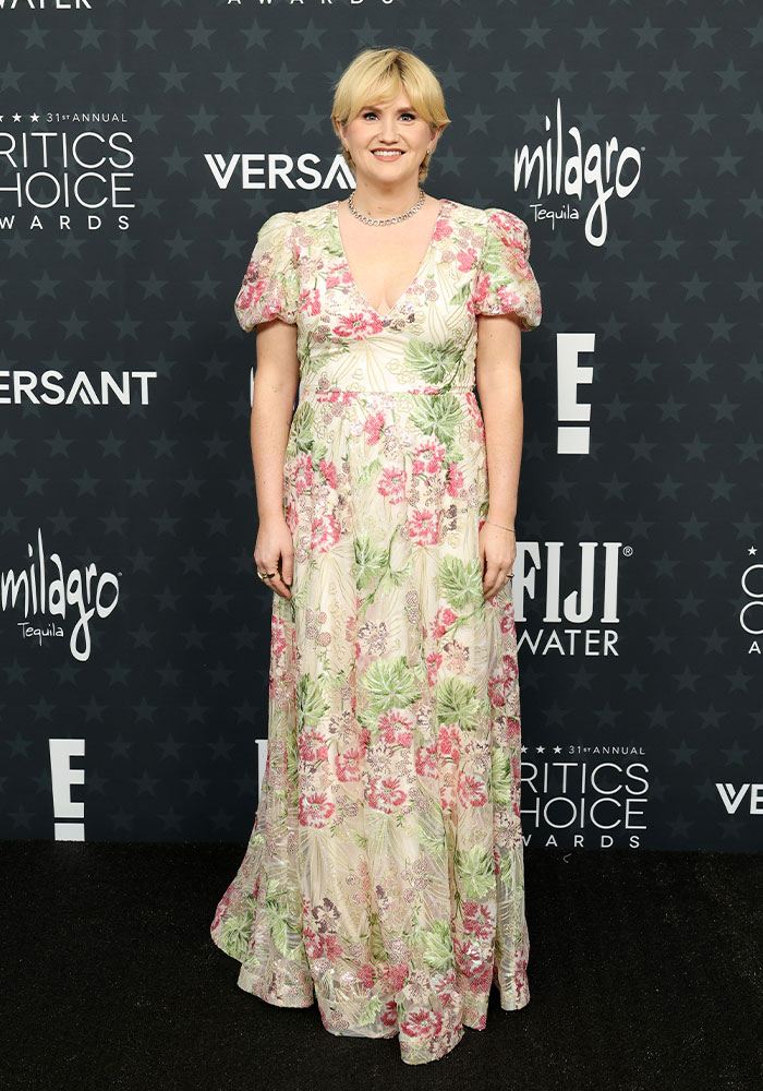 Blonde woman in a floral dress posing on the red carpet at the 2026 Critics Choice Awards worst-dressed celebs event.