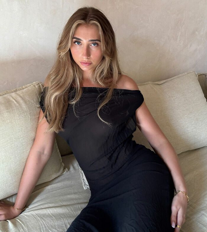Adult star who went viral for 1000 men challenge posing on couch wearing a black dress with loose hair and natural makeup. Adult star who went viral for 1000 men challenge posing on couch wearing a black dress with loose hair and natural makeup.