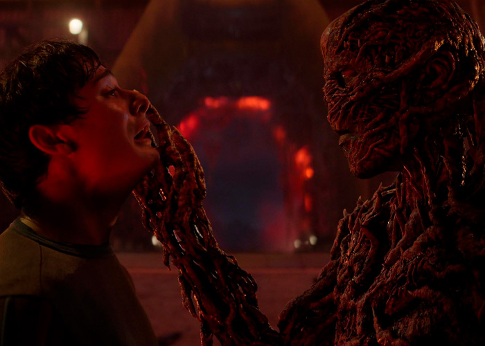 Noah Schnapp as Will Byers in Stranger Things facing a creature with a dark, twisted hand in a red-lit scene. Noah Schnapp as Will Byers in Stranger Things facing a creature with a dark, twisted hand in a red-lit scene.