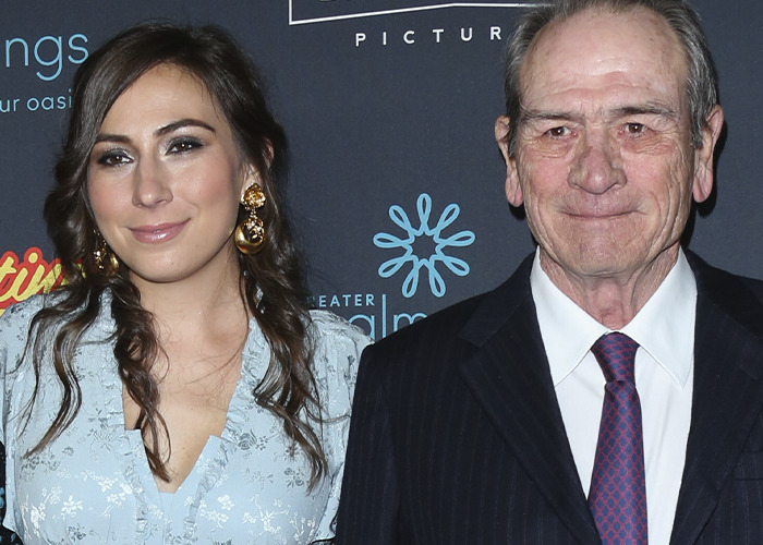 Tommy Lee Jones with daughter Victoria at an event, both dressed formally with a dark backdrop behind them.