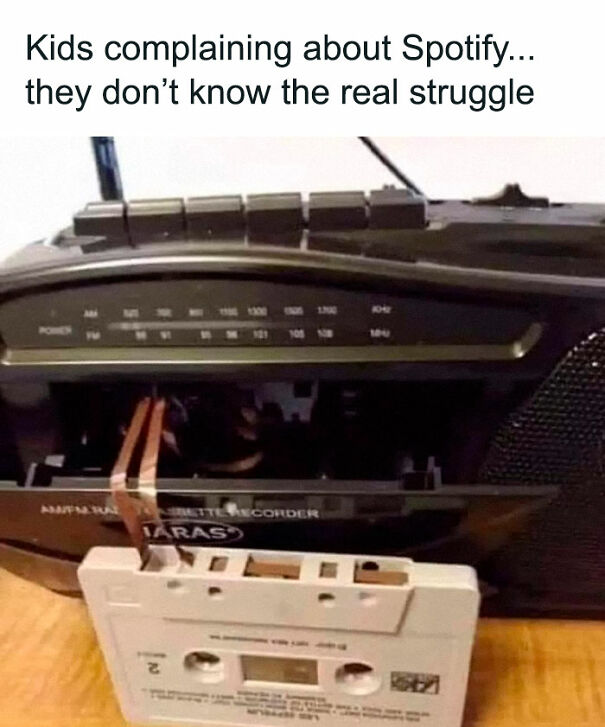 Retro cassette tape being inserted into a tape recorder, highlighting relatable memes about nostalgic music struggles.