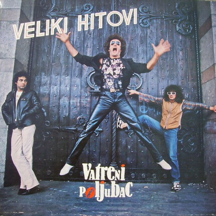 Three men posing awkwardly in front of a large door on a hilariously bad album cover from the 1980s.