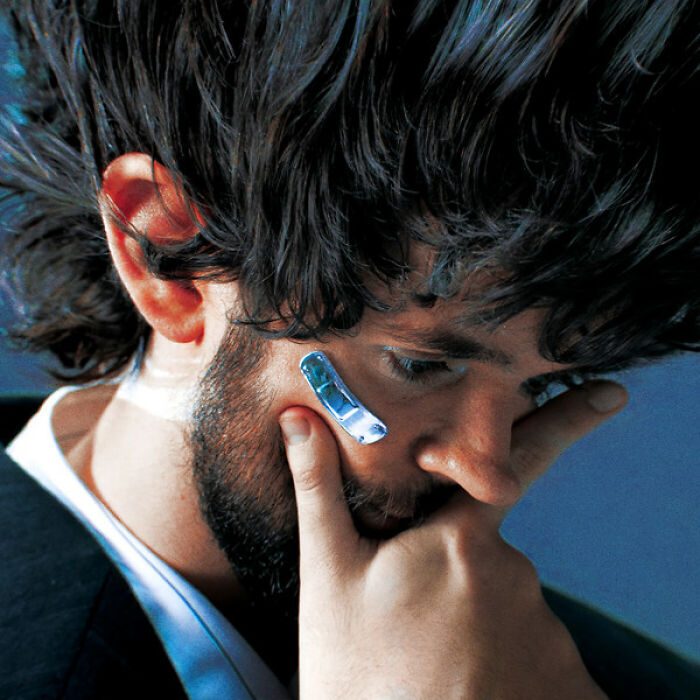 Close-up of a man with a shiny bandage on his cheek, depicting a hilariously bad album cover concept.
