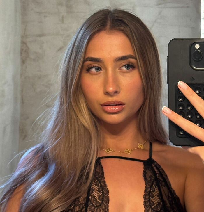 Adult star taking a selfie, showcasing her long hair and makeup, linked to viral 1,000 men in 12 hours challenge. Adult star taking a selfie, showcasing her long hair and makeup, linked to viral 1,000 men in 12 hours challenge.