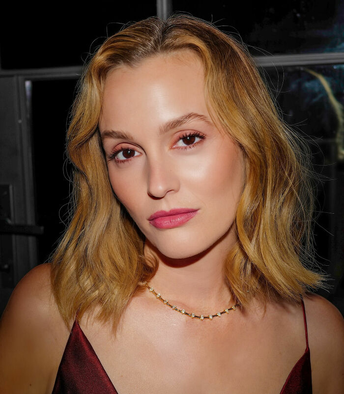 Woman with blonde hair wearing a gold necklace and burgundy top, related to Ariana Grande brutal roast after Leighton Meester mock. Woman with blonde hair wearing a gold necklace and burgundy top, related to Ariana Grande brutal roast after Leighton Meester mock.