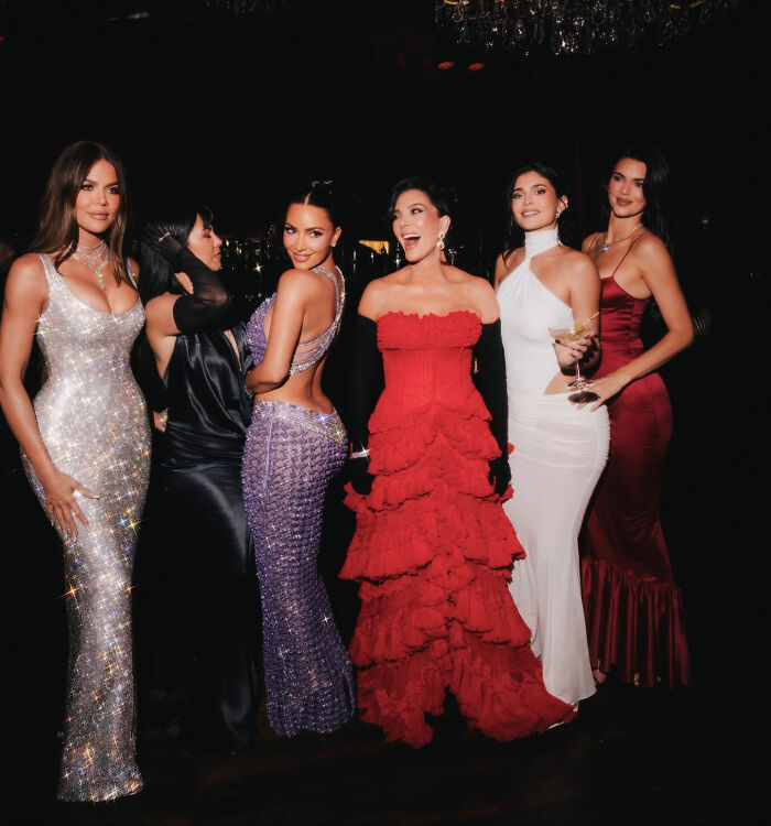 Kim Kardashian and friends dressed glamorously at a party, related to Prince Harry and Meghan Markle photo controversy.