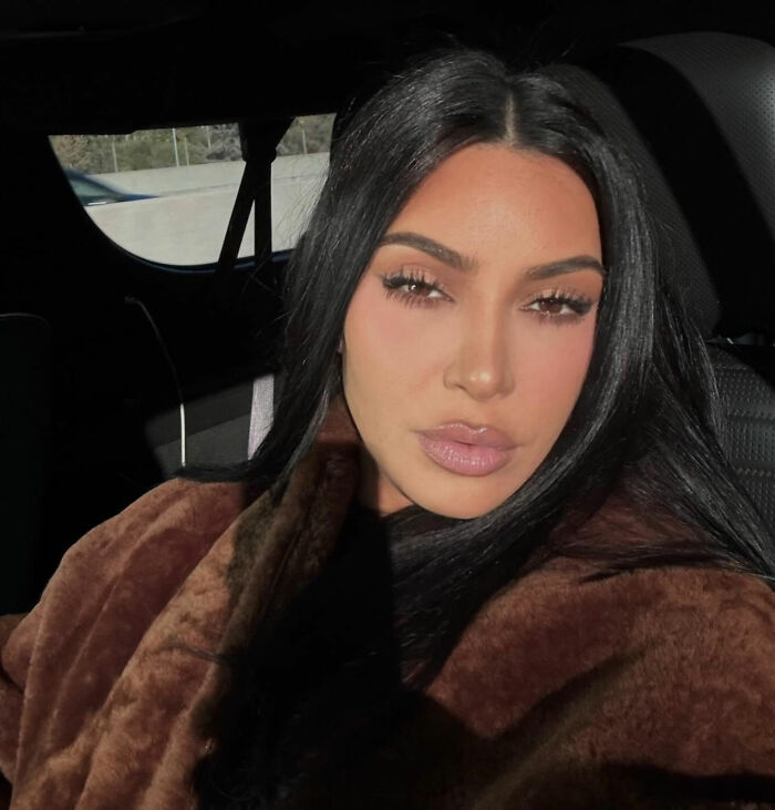 Kim Kardashian in a close-up selfie, wearing a brown coat, sparking suspicion with Taylor Swift comments. Kim Kardashian in a close-up selfie, wearing a brown coat, sparking suspicion with Taylor Swift comments.