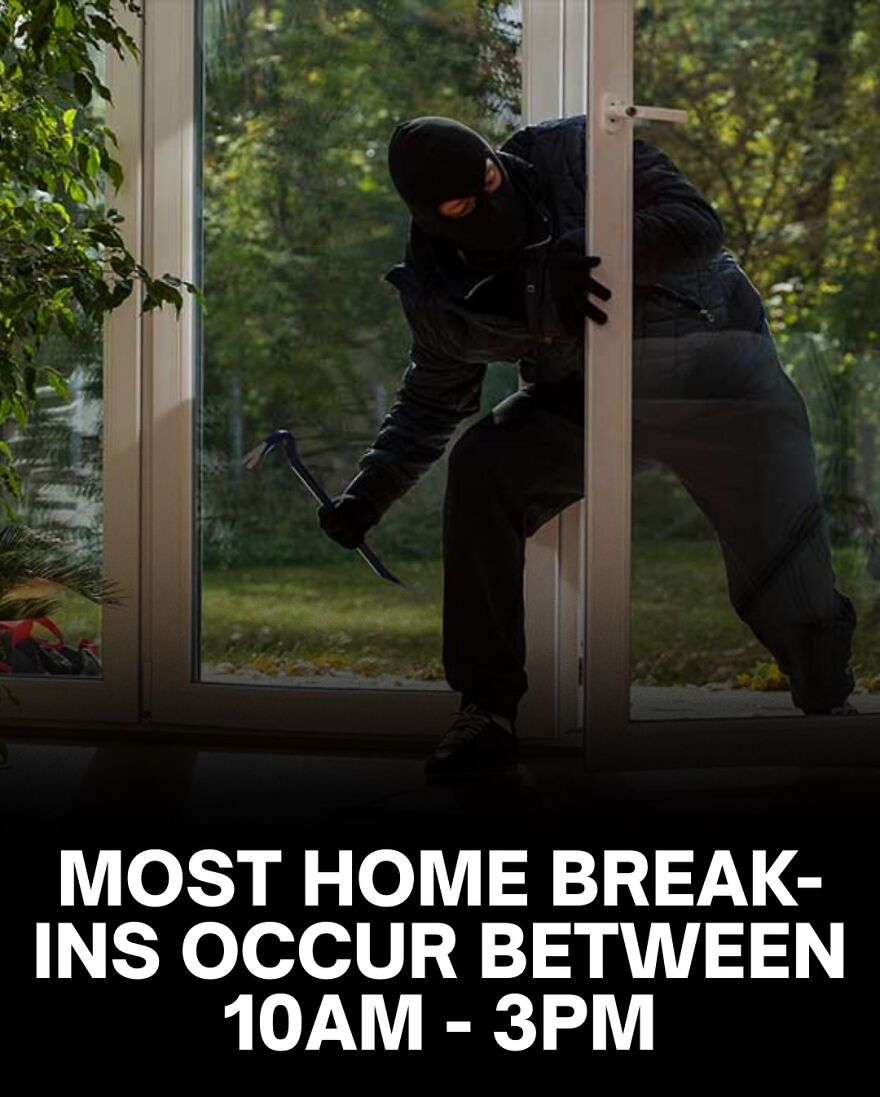 Burglar in dark clothes breaking into home during daytime, highlighting scary facts about home break-ins and safety risks.