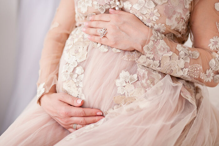 Close-up of a couple’s hands on a wedding dress, symbolizing fastest times couples said I do and relationships.