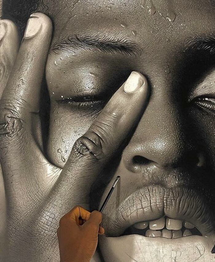 Artist creating a hyperrealistic portrait with detailed skin texture and water droplets on the face.