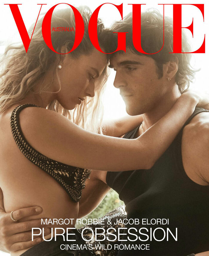 Margot Robbie wearing a bathing suit with sleeves embracing Jacob Elordi on Vogue Australia cover.