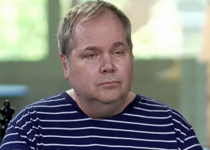 Middle-aged man in a striped shirt speaking in an indoor interview about Hollywood predators and Jodie Foster.