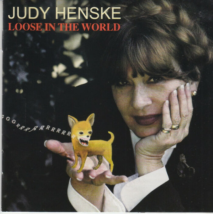 Album cover showing woman holding a small animated snarling dog with text Judy Henske Loose in the World.