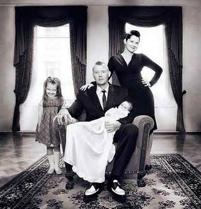 Black and white vintage family portrait with eerie expressions, fitting the odd and creepy theme of old photos.