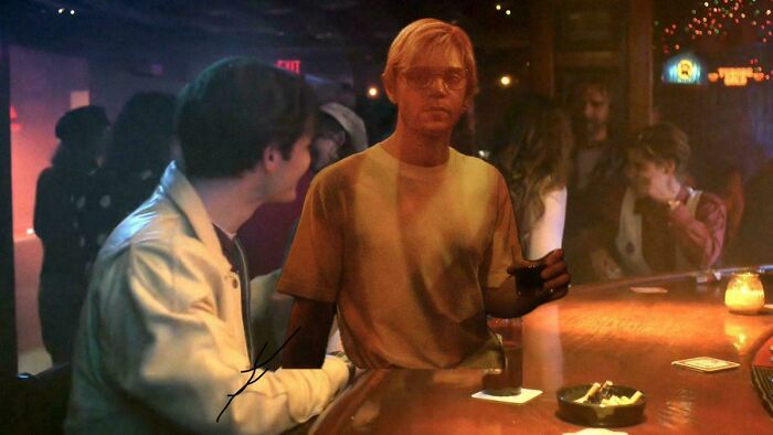 Two Stranger Things characters sitting at a dimly lit bar, reflecting on the show's controversial ending.