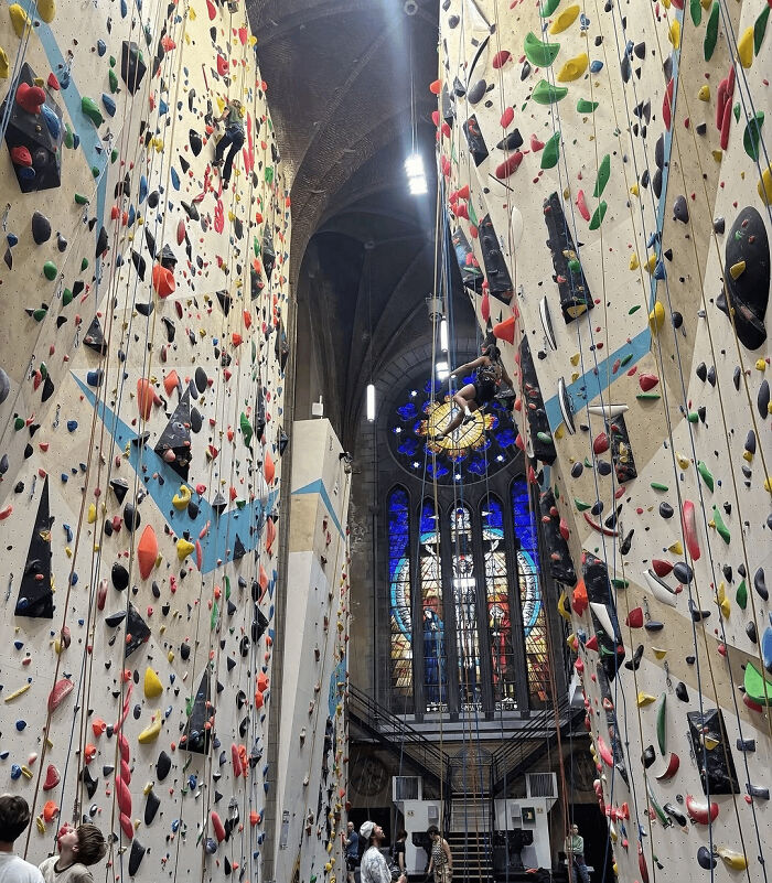 Indoor rock climbing walls inside a cathedral showcasing impressive things countries implemented that left people in awe.