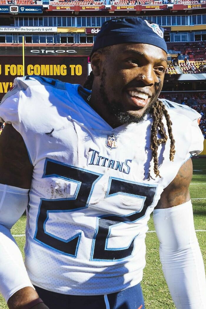 Derrick Henry in Tennessee Titans uniform smiling on the field after an NFL game showing career highlights.