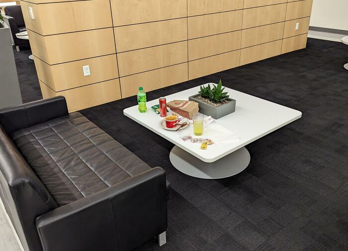 Soda cans, cups and food wrappers abandoned on office lounge table — next-level jerks