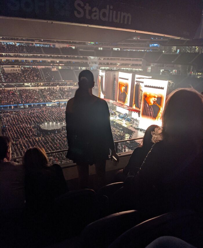 Person standing and blocking stadium concert view, an example of next-level jerks.