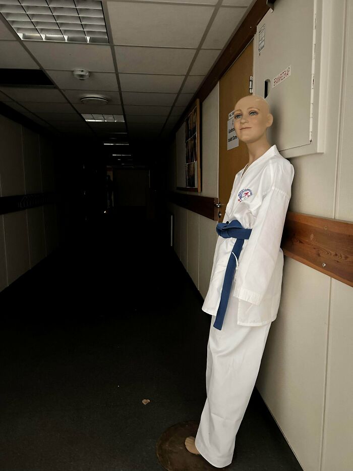 Mannequin dressed in a martial arts uniform standing in a dimly lit hallway, fitting scary posts shared online theme.