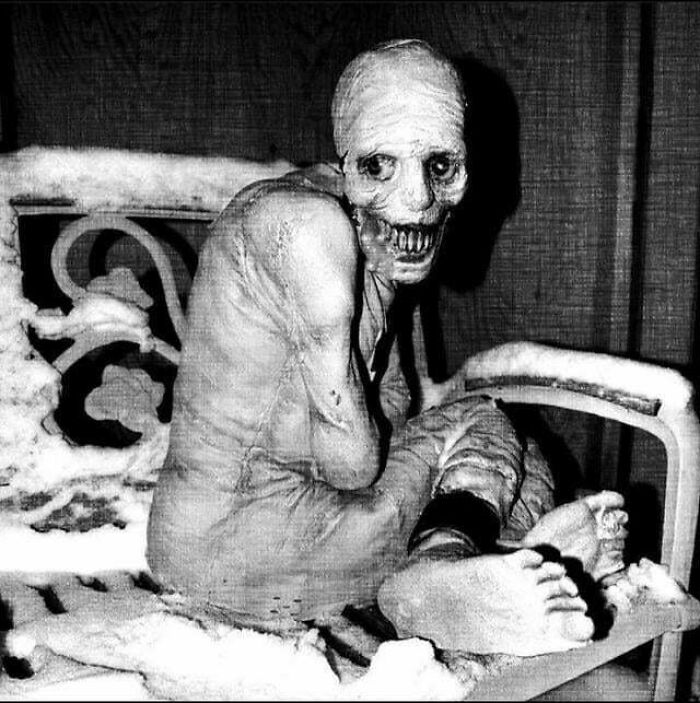 Eerie creature with skeletal face and elongated limbs sitting on a snow-covered bench, one of the scariest posts shared online.