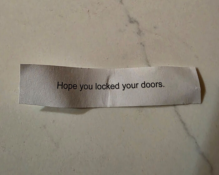 A close-up of a paper slip with the scary message "Hope you locked your doors" shared online.