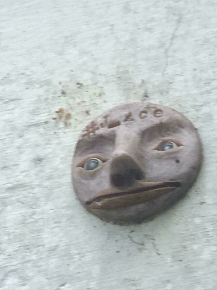 Disturbing carved face sculpture mounted on a wall, evoking eerie and unsettling feelings in scary posts shared online.