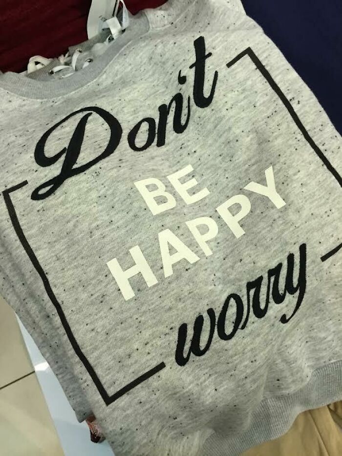 Gray sweatshirt with a misspelled motivational phrase showing a hilarious fashion fail in text design.