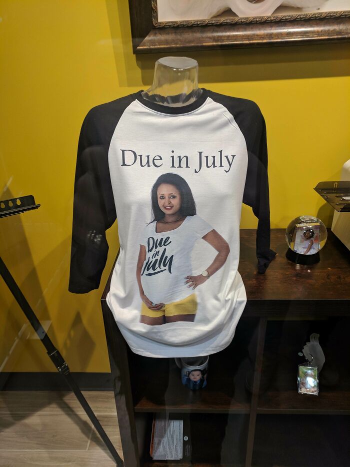Baseball-style shirt with a photo of a pregnant woman and the text Due in July, showcasing hilarious fashion fails.