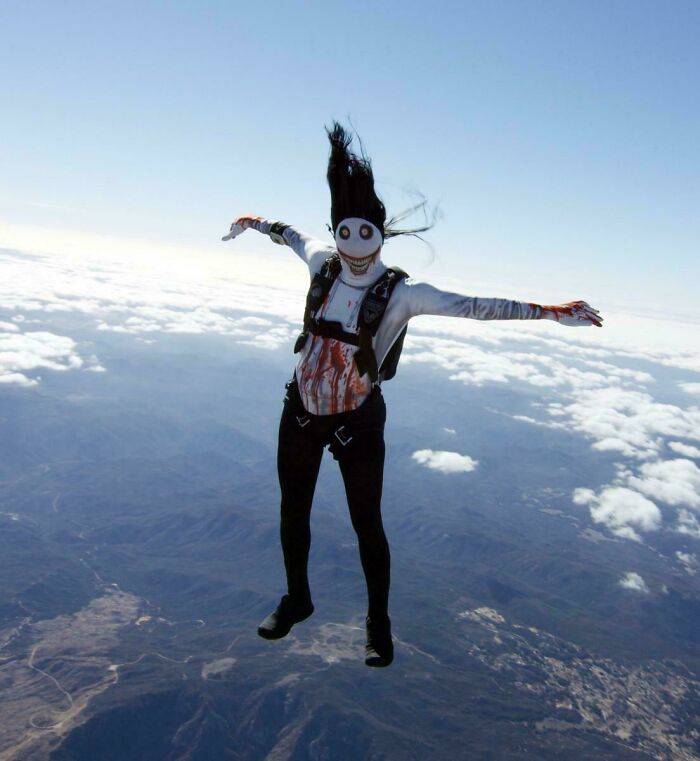 Person skydiving wearing a scary costume with a creepy mask and blood-stained clothes, one of the scariest posts online