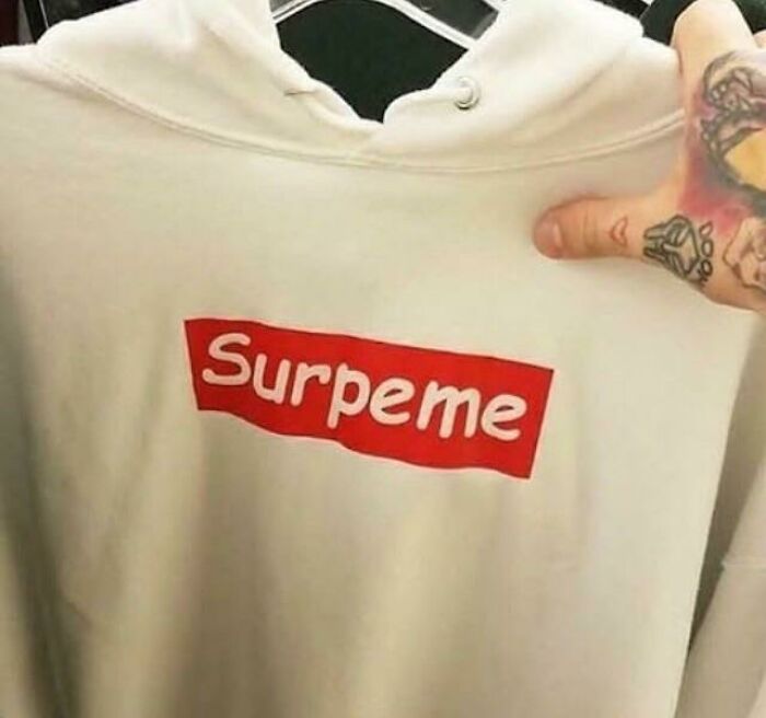 White hoodie with a misspelled red logo showing hilarious fashion fails in casual streetwear style.