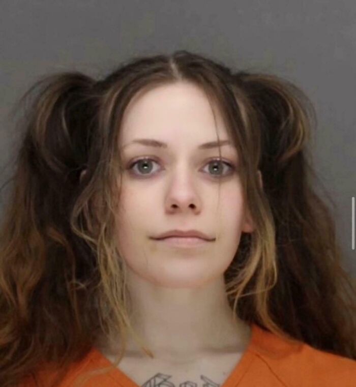 Young woman with disheveled hair wearing an orange shirt, a chilling image fitting the scariest posts shared online theme.