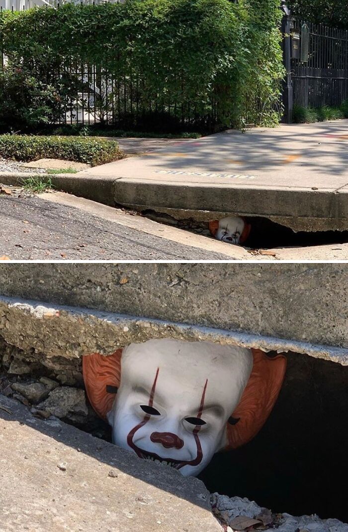 Creepy clown mask peeking from a street drain, one of the weirdest things found in the streets.