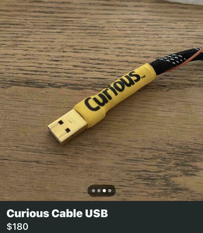 Yellow USB cable labeled Curious on a wood table, example of unhinged things sold online