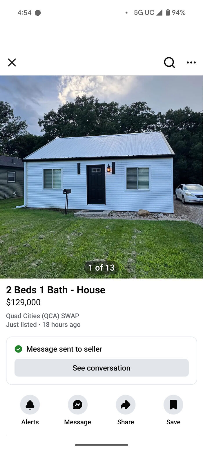 Small white house with metal roof and lawn listed for sale, mailbox and parked car — unhinged things for sale online