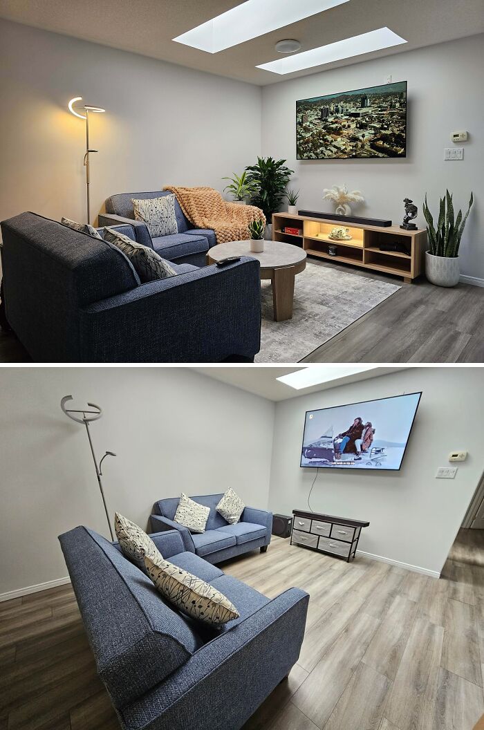 Modern living room decorated with blue sofas, plants, and a large wall-mounted TV in a stylish home interior.
