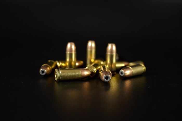 Close-up of brass bullets on a dark surface symbolizing hidden dangers and family secrets revealed in personal stories.