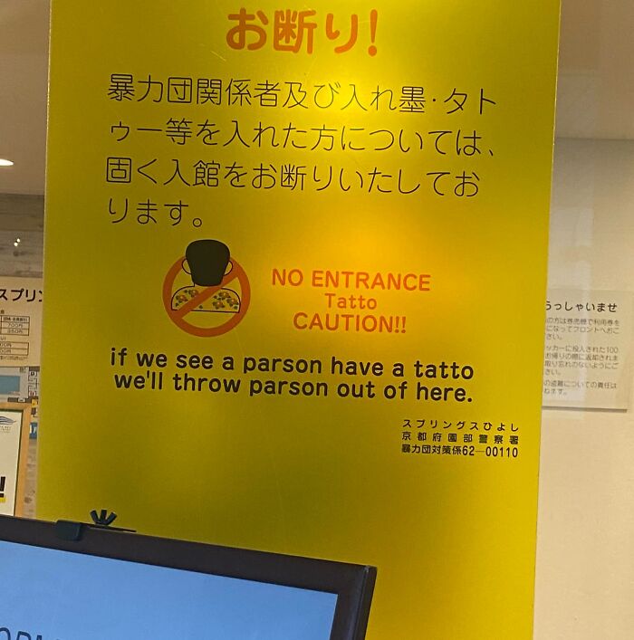 Yellow sign with humorous English translation errors warning tattooed persons will be thrown out, showing Japan getting lost in translation.