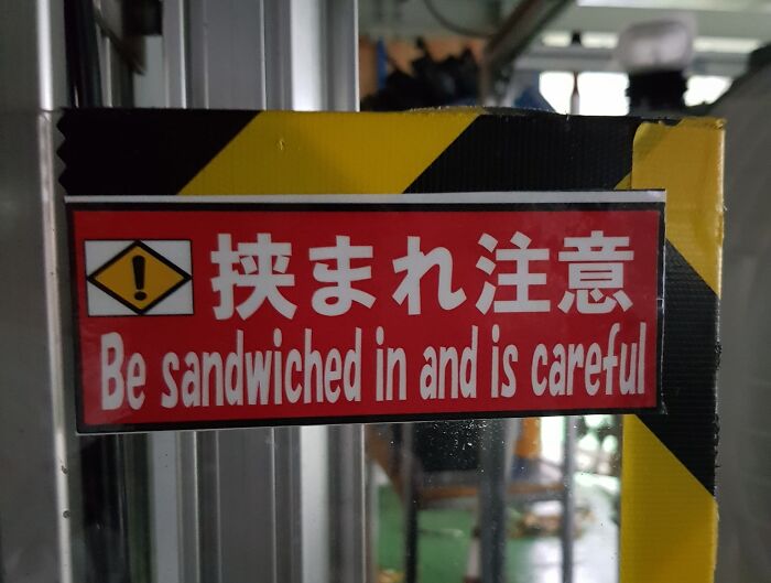 Japanese translation fail on red warning sign saying Be sandwiched in and is careful, showcasing translation errors.