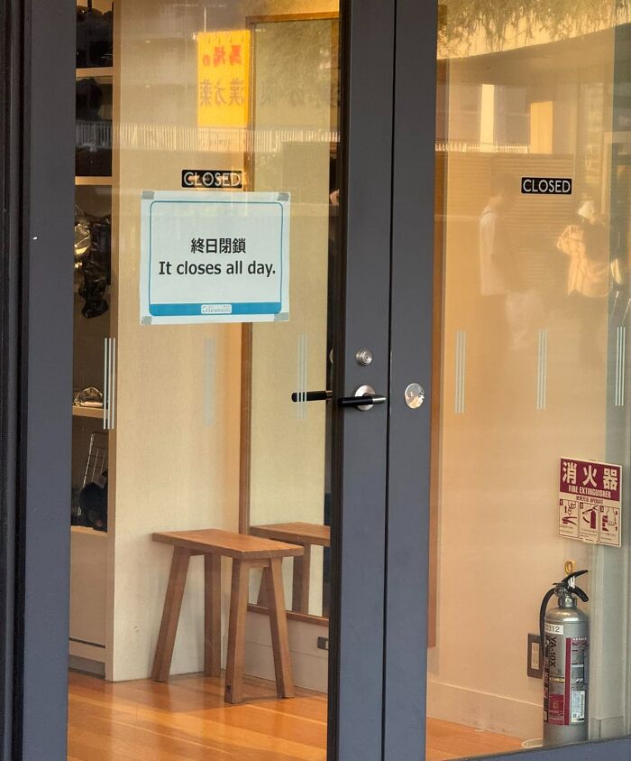 Glass door with a sign saying It closes all day, showing a hilarious case of Japan getting lost while translating to English.