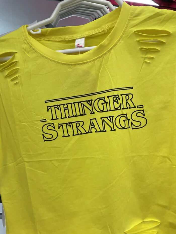 Yellow distressed t-shirt with misspelled text and shredded shoulders, showcasing hilarious fashion fails in casual wear.