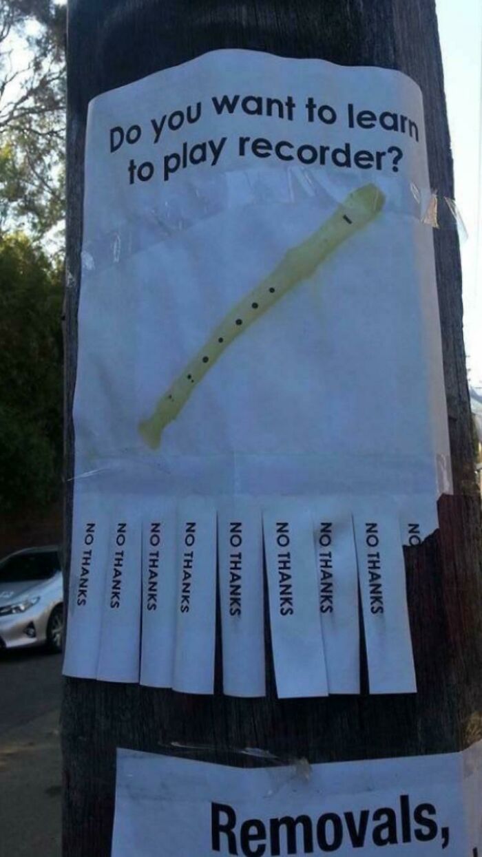 Funny confusing picture of a recorder lesson flyer with tear-off tabs all saying no thanks on a wooden pole outdoors.